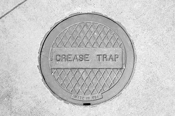 during grease trap pumping, the contents of the trap are removed and disposed of properly